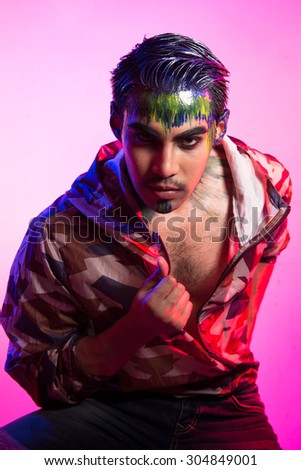 Portrait with Colorful Makeup, Hair and Accessories. Colourful Studio Shot of Funny man . Vivid Colors. Manicure and Hairstyle. Rainbow Colors