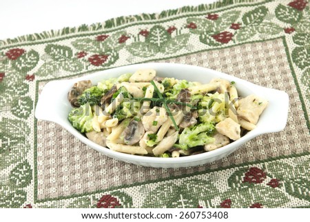 A delicious Italian meal, chicken pasta primavera, with chicken, broccoli, penne pasta, mushrooms in a creamy alfredo sauce