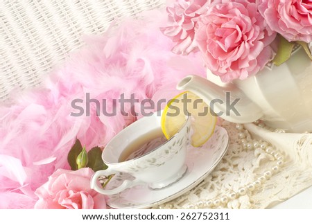 A Mothers Day tea party still life, with fresh hot tea with lemon, and fresh pink roses, plenty of space for text