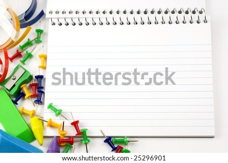 Blank ruled index card with colorful school and office supplies around edge  copy space