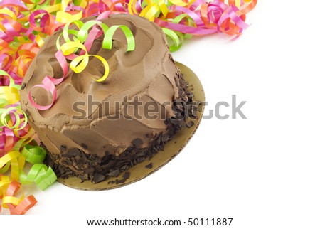 A chocolate fudge layer cake with colorful party ribbons, white horizontal background with copy space, diagonal viewpoint