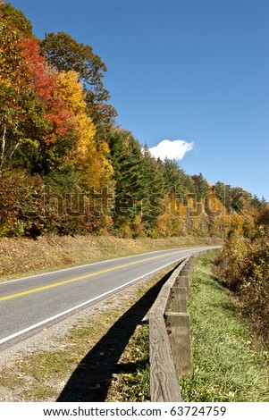 Beautiful fall trees and blue sky with winding road in the Great Smoky Mountains