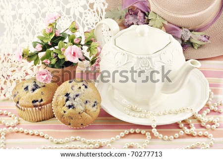 A ladies pretty tea party with blueberry muffins, antique lace and pearls
