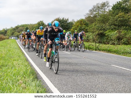 HONITON, UK - SEPTEMBER 20: Bradley Wiggins wears the IG Yellow Jersey as current tour leader, in the pack of the Devon stage of the Tour of Britain cycle race on September 20, 2013 in Honiton, UK