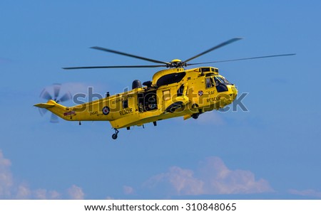 DAWLISH, UNITED KINGDOM - AUGUST 23, 2014: Royal Navy Sea King Search and Rescue Helicopter Flying at the Dawlish Airshow