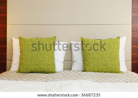 hotel bedroom with green pillow