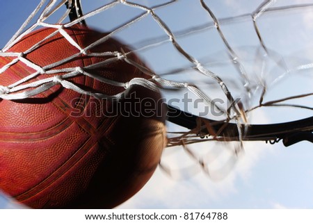 Picture of a basketball field goal with the sky in background.
