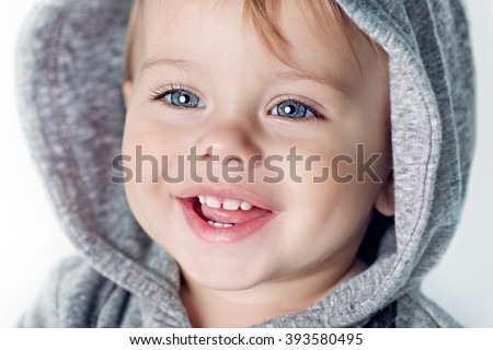 Image of  sweet baby boy, closeup portrait of child isolated on white background, cute toddler with blue eyes