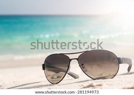 Sunglasses on the tropical beach. Travel relax vacation - azure sea, white sand, shining sun, Summer paradise day on exotic bay Grand Anse, La Digue Island, Seychelles, Indian Ocean