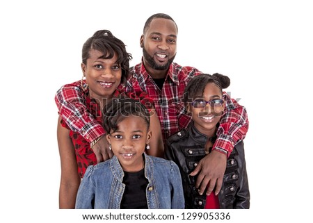 A happy family of four people on white background with the father hugging them all