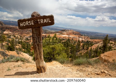 wooden horse-trail sign in the deserted red rock mountains