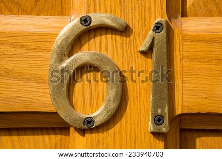 metal number installed on wood door