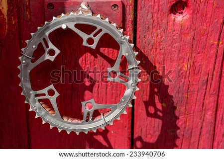 recycled bike crank as a door handle on a red vintage door