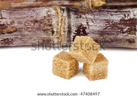 brown sugar with sugar cane isolated on white