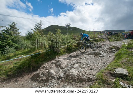 FORT WILLIAM 2014 UCI WORLD CUP, SCOTLAND - 8 JUNE 2014: Downhill World Cup. Competitor in the Junior Mens event races down the track, to finish in 9th place