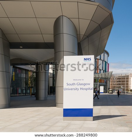 GLASGOW, SCOTLAND, UK - 17 JUNE 2015: South Glasgow University Hospital (now renamed Queen Elizabeth University Hospital) main entrance with the colourful Royal Hospital For Sick Children behind
