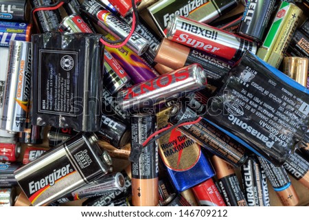 FAIRFAX, VA - JULY 16: Different types of used batteries ready for recycling lying in a heap at a recycling center on July 16, 2013 in Fairfax, VA. Types are AAA, AA, 9-volt and cordless phones.