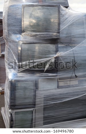 Stacked televisions wrapped on a palette for electronic recycling