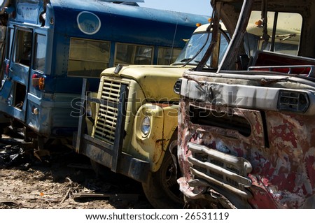 Wrecked buses and truck in a junkyard