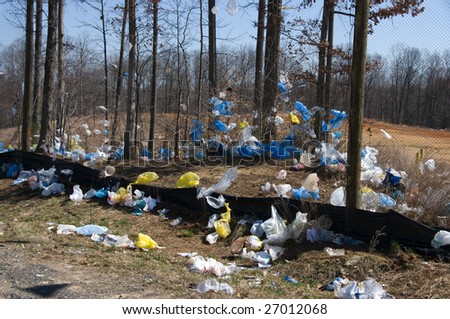 Plastic bags blown by wind from a landfill
