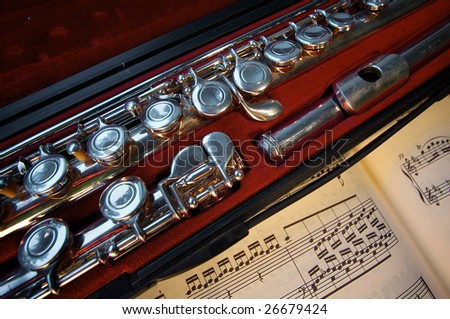 transverse flute in a case with note paper, musical instrument