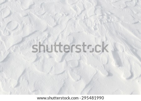 Fresh snow background - windswept, abstract, sculpted, dynamic snow texture
