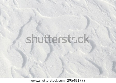 Fresh snow background - windswept, abstract, sculpted, packed snow texture