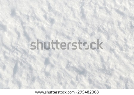 Fresh snow background - packed, wind blown rough texture close-up