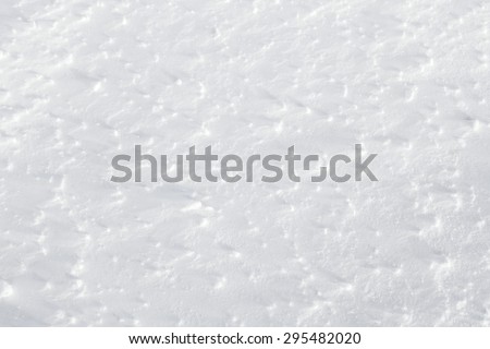 Fresh snow background - packed, wind blown texture close-up