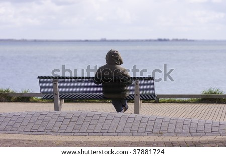 Lonely depressed person on bench