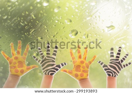 Hand Painted Child. Isolated on white background.animal hand paint concept.giraffe and zebra hand paint on window with water drop background.