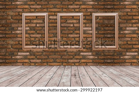 Grunge gold wooden frame on the brick wall and floor wood.