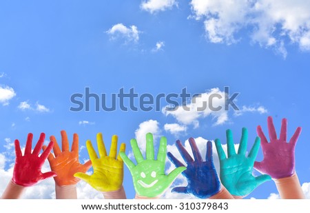 Hand Painted Child. hand paint on blue sky background.rainbow hand paint.