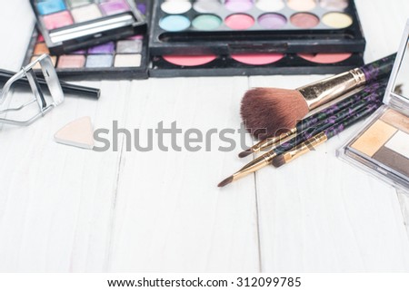 close up shadow kit with brushes for make-up.beauty background.
