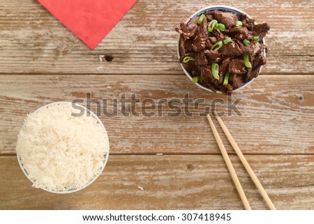 Concept of Chinese food. Beef cooked in soy sauce with spring onions and star anise served in a china bowl.
