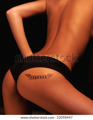 stock photo Sexy girl with tattoo FOREVER on her ass