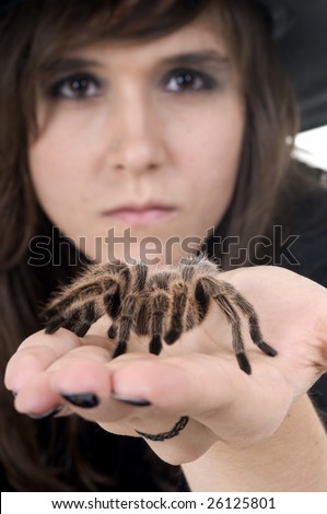 Witch showing no fear of the big spider on her hand