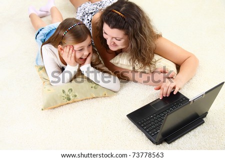 Mom and daughter spend time with laptop