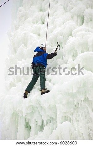 Man climbing ice cliff
