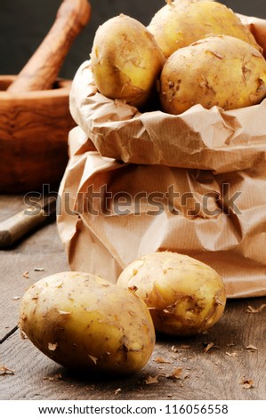 Fresh organic potatoes in a brown paper bag