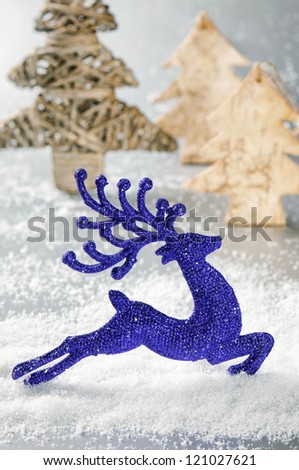 Christmas deer running in sunny snowing forest