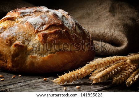 Freshly baked traditional bread on wooden table