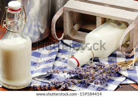 Bottles with fresh milk in countryside setting