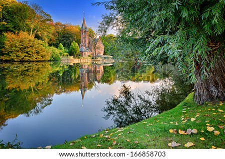 Autumn Landscape With Lake And Old Mansion. Bruges, Belgium