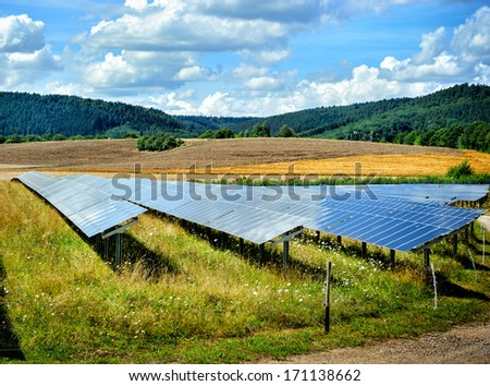 Landscape with solar energy field at sunny summer day