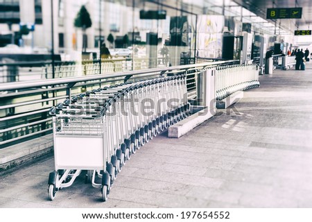 Luggage carts in front of airport entrance