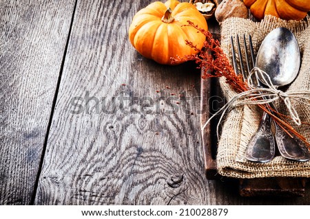 Seasonal table setting with small pumpkins