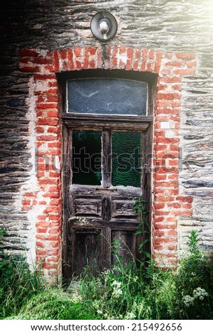 Ancient wooden door in abandoned country house