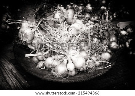Fresh onions in rustic setting. Black and white concept