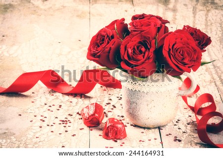 Valentine\'s setting with bouquet of red roses and chocolate